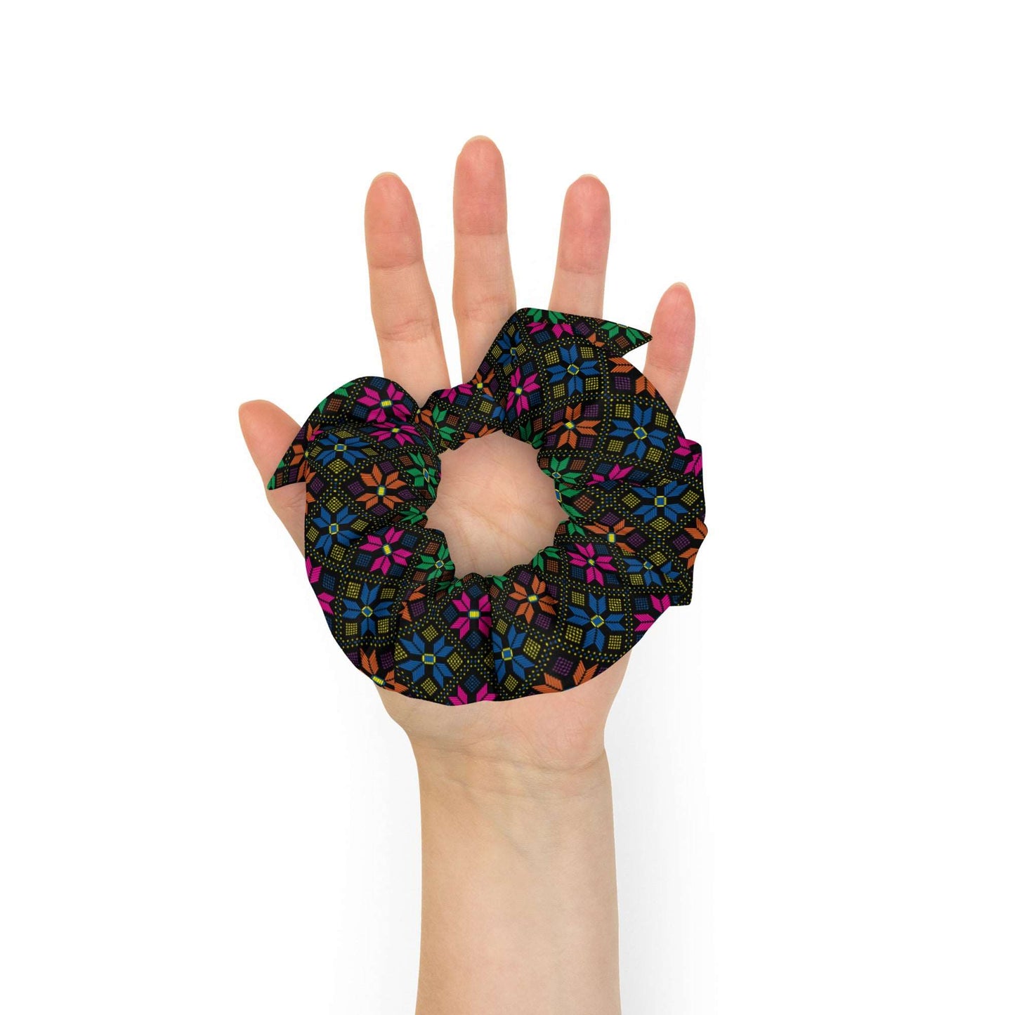 Synth Flower Recycled Scrunchie | Black Multicolor, a black scrunchie made of recycled materials with a bright pattern of pink, blue, orange, and green flowers with blue and yellow dots.