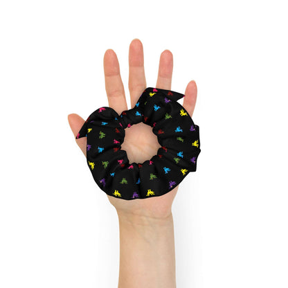 Little Ducks Recycled Scrunchie | Black Multicolor, a black scrunchie made of recycled materials with bright yellow, pink, blue, purple, maroon, and green ducks printed on it.