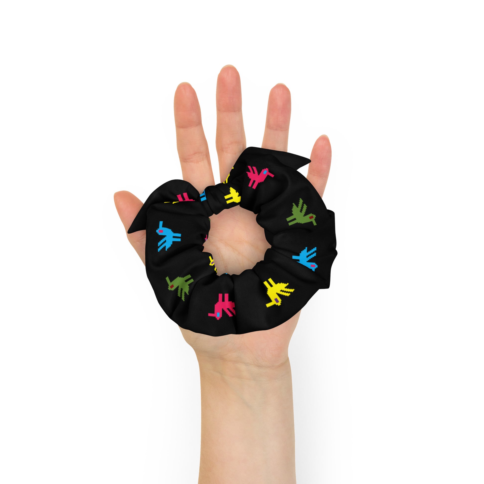 Ducks Recycled Scrunchie | Black Multicolor, a black scrunchie made of recycled materials with bright yellow, pink, blue, and green ducks printed on it.