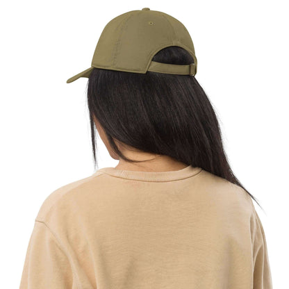 The back of a woman wearing a khaki green baseball cap made of 100% organic cotton. It shows the back adjustable strap.