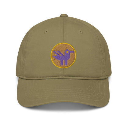 A khaki green baseball cap made of 100% organic cotton with an embroidered patch on the front. The patch is an orange circle with a yellow border with a purple retro duck inside.