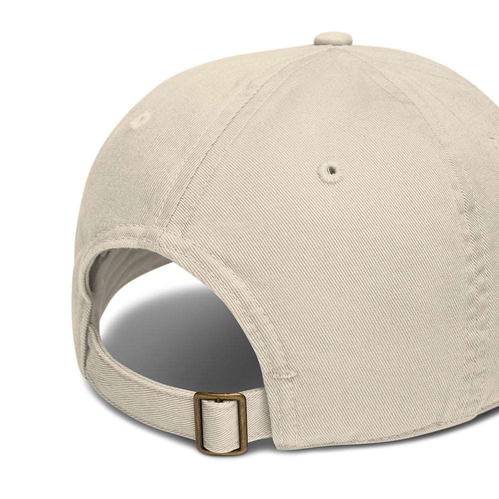 The side and back of a light tan baseball cap made of 100% organic cotton. It shows an adjustable band.