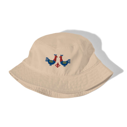 Roosters Organic bucket hat, a tan bucket hat with a pair of large red and blue roosters with yellow details embroidered on the front.