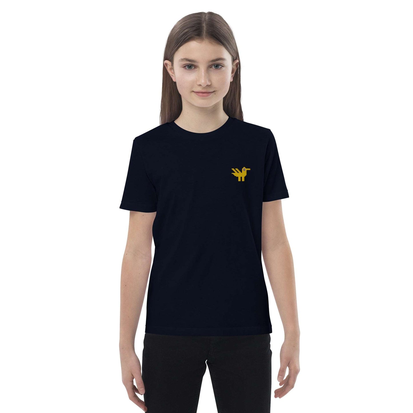 A girl wearing a dark navy kids t-shirt made of 100% organic cotton with a yellow duck embroidered on the top left.