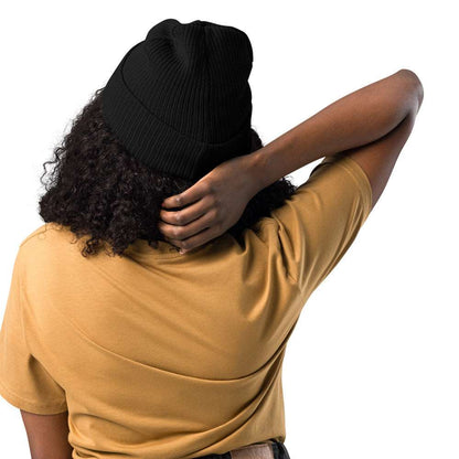 The back of a woman wearing a ribbed black beanie made of 100% organic cotton..