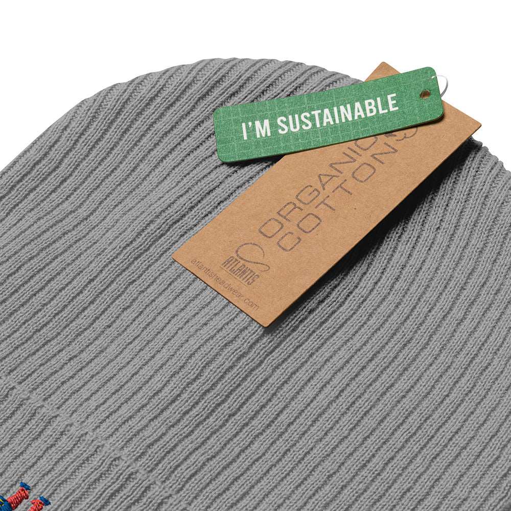 Detail of the tags on light grey a 100% organic cotton ribbed beanie. They say "I'm Sustainable" and "Organic Cotton".