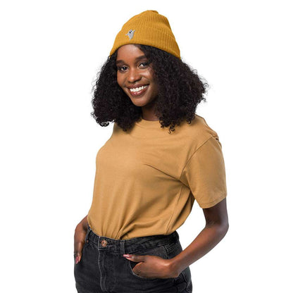 A woman wearing a mustard yellow spooky Halloween ribbed beanie made of 100% organic cotton with a ghost embroidered on the front.