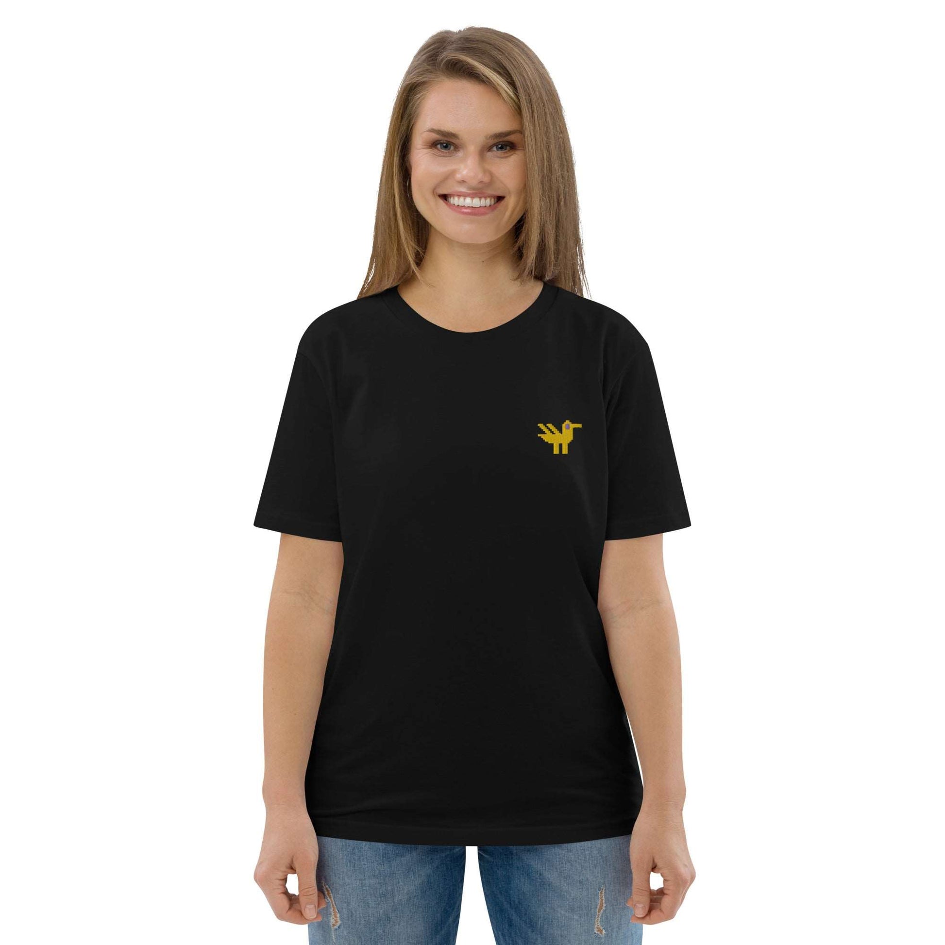 A woman wearing a black t-shirt made of 100% organic cotton with a yellow duck embroidered on the top left.