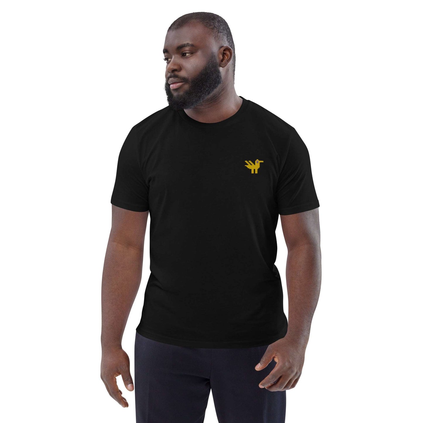 A man wearing a black t-shirt made of 100% organic cotton with a yellow duck embroidered on the top left.