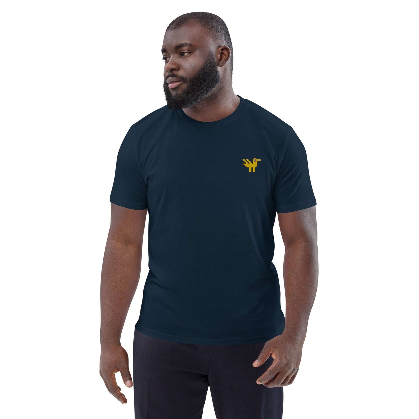 A man wearing a dark navy t-shirt made of 100% organic cotton with a yellow duck embroidered on the top left.