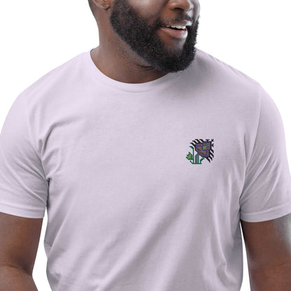 A close-up of a man wearing a purple t-shirt made of 100% organic cotton with an intricate purple flower embroidered on the top left.