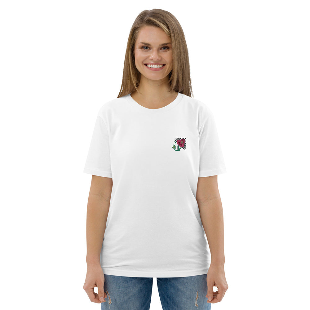 A woman wearing a white t-shirt made of 100% organic cotton with an intricate pink flower embroidered on the top left.