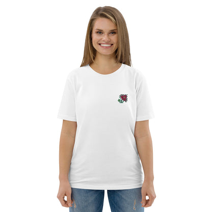 A woman wearing a white t-shirt made of 100% organic cotton with an intricate pink flower embroidered on the top left.