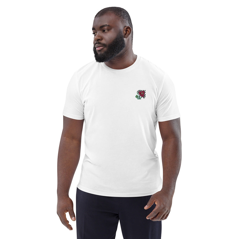 A man wearing a white t-shirt made of 100% organic cotton with an intricate pink flower embroidered on the top left.