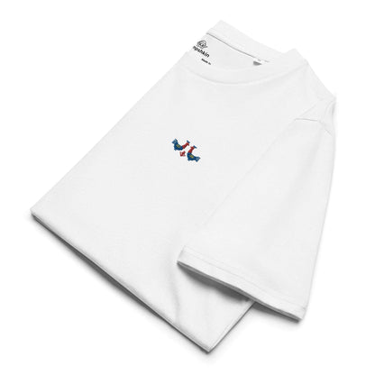 A white t-shirt made of 100% organic cotton with a pair of red and blue roosters embroidered on the top left. The shirt is folded showing the embroidery detail and the left sleeve.