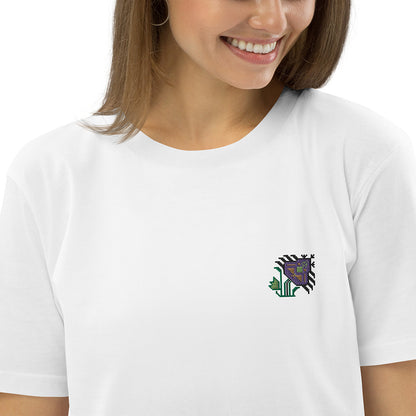 A close-up of a woman wearing a white t-shirt made of 100% organic cotton with an intricate purple flower embroidered on the top left.