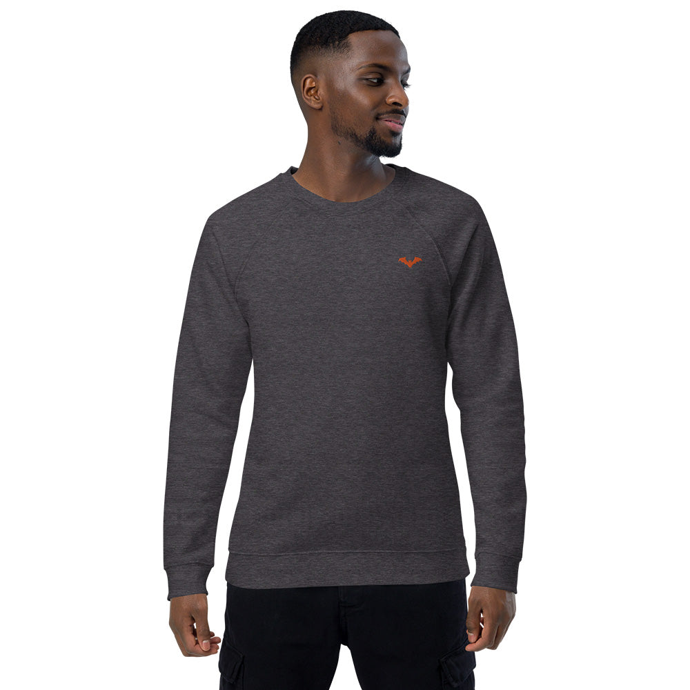 A man wearing a spooky Halloween charcoal grey sweatshirt with a small orange bat embroidered on the top left.