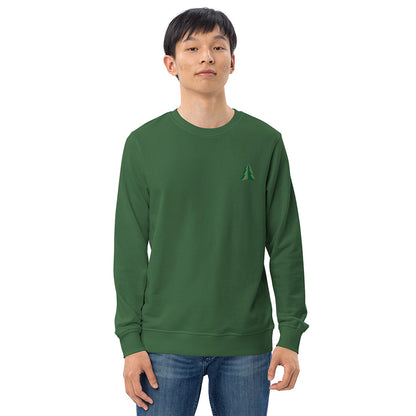 A man wearing a festive green Christmas sweatshirt made of organic cotton and recycled polyester with a small minimalist two-tone pine tree embroidered on the top left.